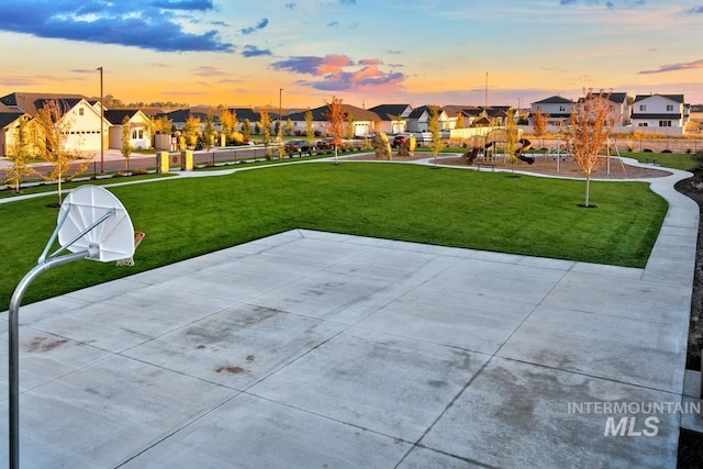 view of home's community featuring community basketball court, a residential view, playground community, and a yard