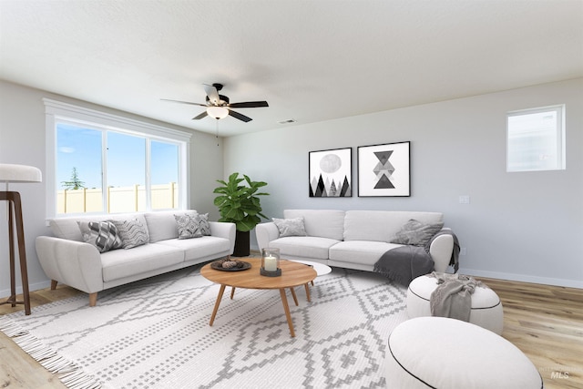 living room featuring visible vents, wood finished floors, a ceiling fan, and baseboards