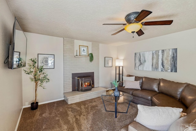 living room featuring carpet, a ceiling fan, a wood stove, a textured ceiling, and baseboards