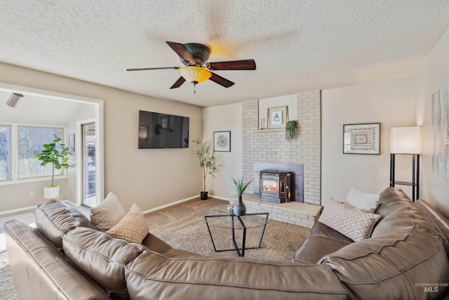 living room featuring carpet, ceiling fan, and a textured ceiling