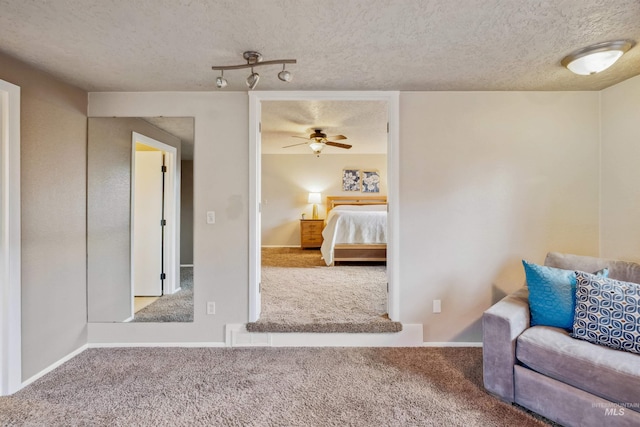 unfurnished bedroom featuring carpet, baseboards, and a textured ceiling