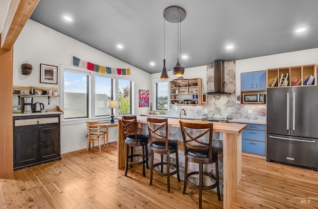 2809 Hampton Ct, Moscow, ID 83843 - kitchen with appliances with stainless steel finishes, open shelves, wall chimney exhaust hood, wooden counters, and vaulted ceiling