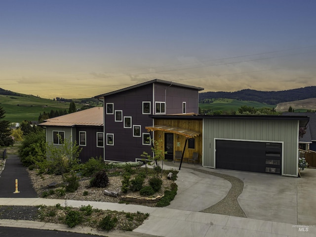 2809 Hampton Ct, Moscow, ID 83843 - contemporary home with a garage, driveway, a mountain view, and board and batten siding