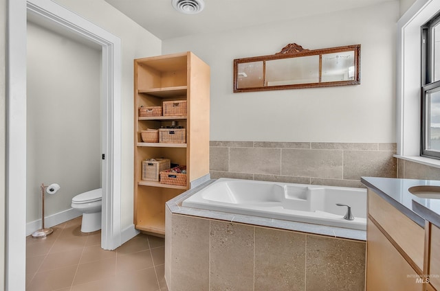2809 Hampton Ct, Moscow, ID 83843 - full bathroom with toilet, a garden tub, vanity, and tile patterned flooring