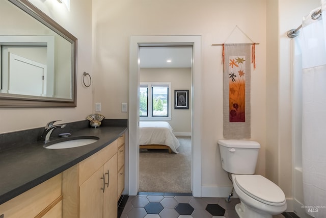 2809 Hampton Ct, Moscow, ID 83843 - full bathroom featuring vanity, tile patterned floors, toilet, baseboards, and ensuite bath