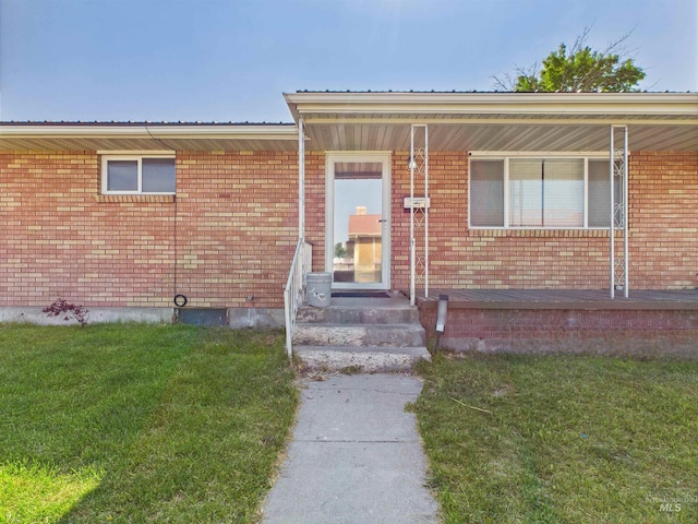 2101 Albion Ave, Burley, ID 83318 - view of exterior entry featuring a lawn, metal roof, and brick siding