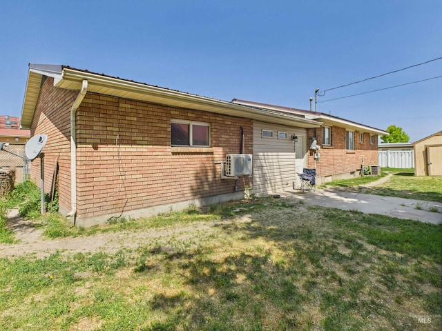 2101 Albion Ave, Burley, ID 83318 - back of property with brick siding, a yard, and a cooling unit
