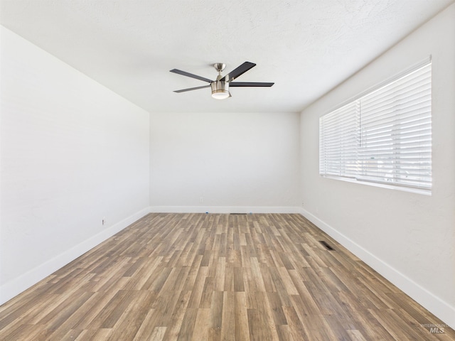 2101 Albion Ave, Burley, ID 83318 - unfurnished room featuring ceiling fan, wood finished floors, and baseboards