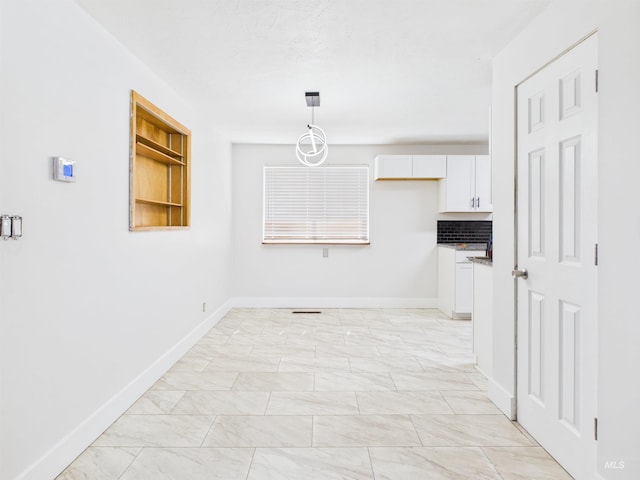 2101 Albion Ave, Burley, ID 83318 - unfurnished dining area featuring baseboards and light marble finish flooring