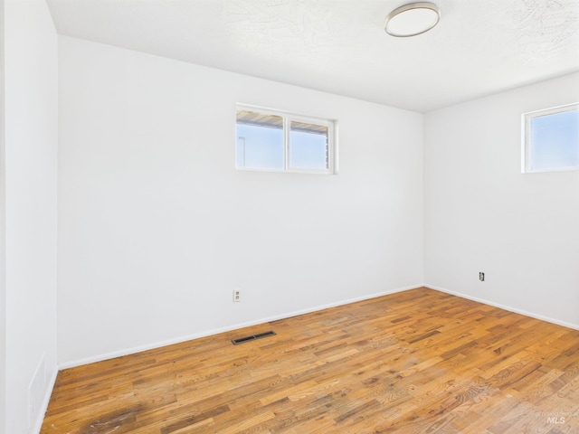 2101 Albion Ave, Burley, ID 83318 - unfurnished room featuring wood finished floors, healthy amount of natural light, and baseboards