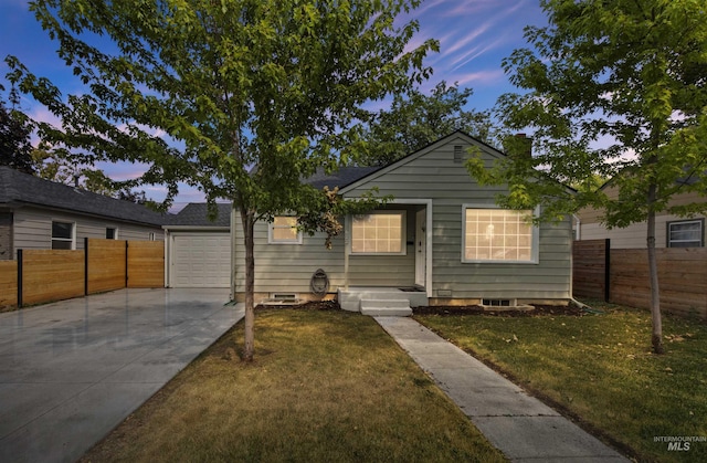 view of front of property featuring a garage and a lawn