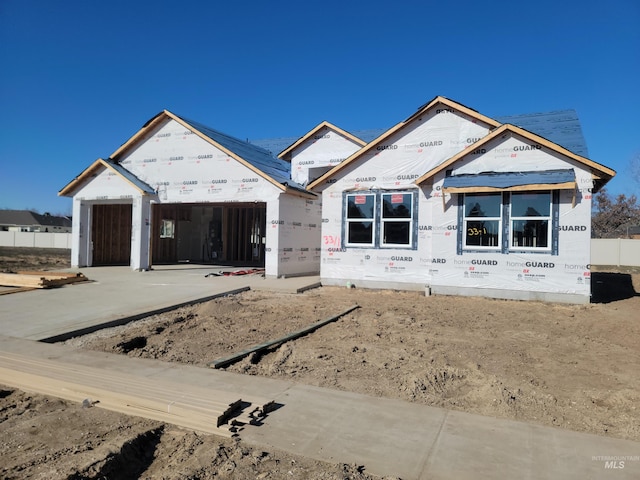 property in mid-construction with a garage and driveway