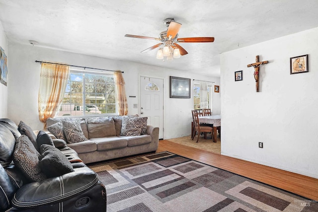 living room featuring dark hardwood / wood-style floors and ceiling fan