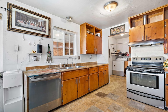 kitchen featuring stainless steel appliances, washing machine and dryer, sink, and light tile floors