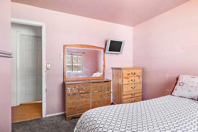 bedroom featuring dark carpet