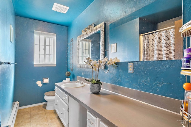 bathroom featuring tile flooring, large vanity, toilet, and a baseboard heating unit