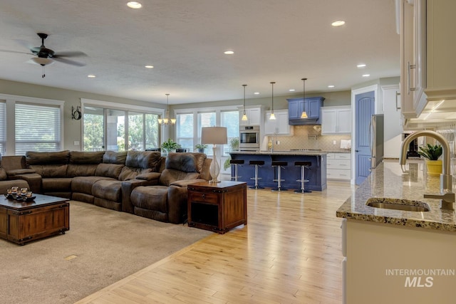3214 S Arctic Fox Ave, Eagle, ID 83616 - living area with a ceiling fan, light wood-style flooring, and recessed lighting