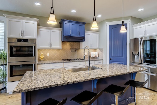 3214 S Arctic Fox Ave, Eagle, ID 83616 - kitchen featuring appliances with stainless steel finishes, light wood finished floors, decorative backsplash, white cabinets, and recessed lighting