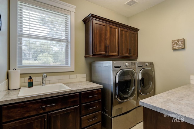 3214 S Arctic Fox Ave, Eagle, ID 83616 - laundry room featuring cabinet space and washing machine and clothes dryer