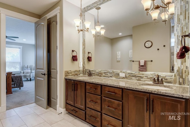 3214 S Arctic Fox Ave, Eagle, ID 83616 - bathroom with a chandelier, double vanity, ceiling fan, tasteful backsplash, and tile patterned flooring