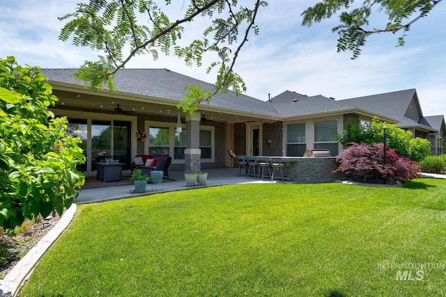 3214 S Arctic Fox Ave, Eagle, ID 83616 - rear view of house with a yard, a ceiling fan, a patio, and stucco siding