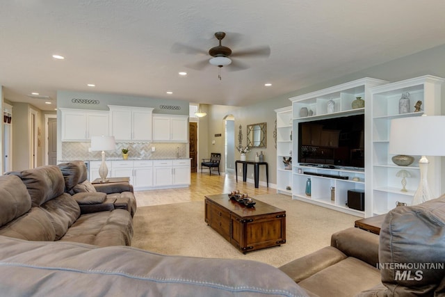 3214 S Arctic Fox Ave, Eagle, ID 83616 - living room featuring a ceiling fan, arched walkways, recessed lighting, and light wood-type flooring