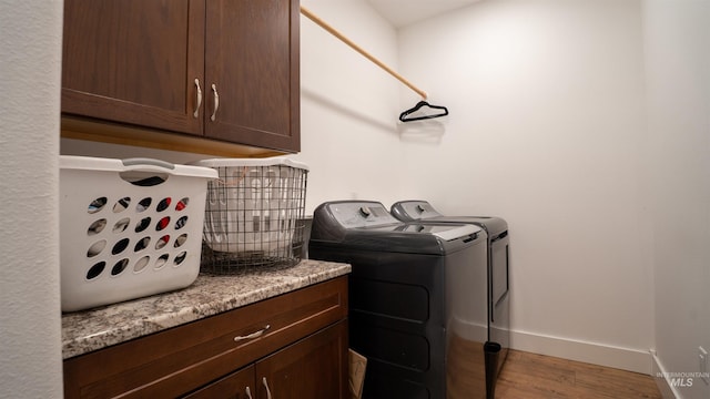 1147 Driscoll Ridge Rd, Troy, ID 83871 - laundry area with washer and dryer, wood finished floors, baseboards, and cabinet space