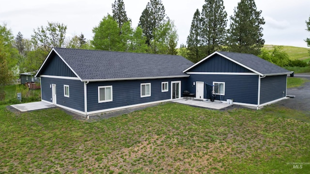 1147 Driscoll Ridge Rd, Troy, ID 83871 - rear view of house with a patio area, a shingled roof, and a lawn