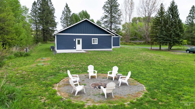 1147 Driscoll Ridge Rd, Troy, ID 83871 - rear view of property with a fire pit, a yard, and board and batten siding