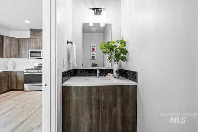 bathroom with vanity and hardwood / wood-style floors