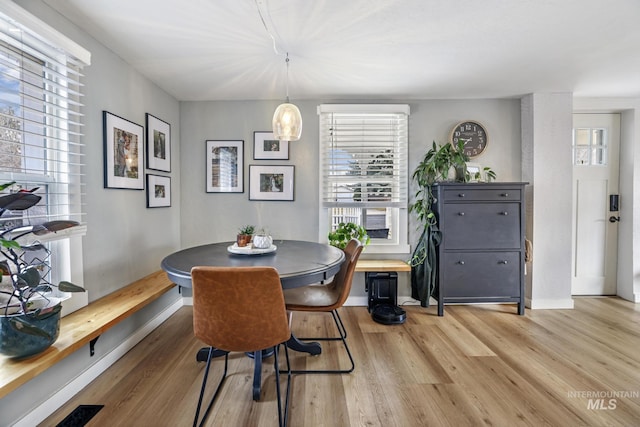 dining area featuring breakfast area, light wood-type flooring, and baseboards