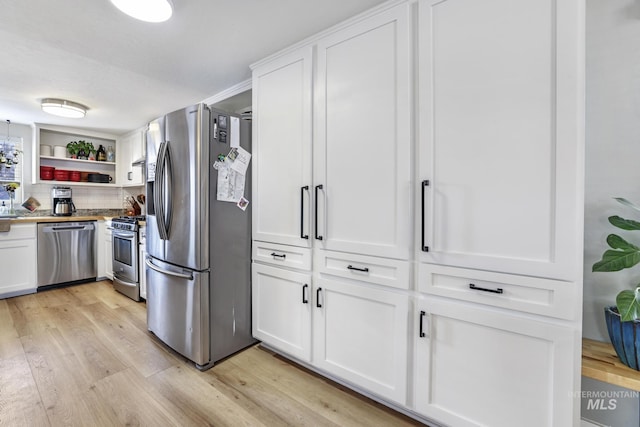 kitchen featuring stainless steel appliances, light wood-type flooring, white cabinets, and open shelves