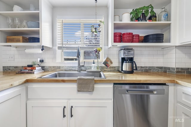 kitchen with tasteful backsplash, white cabinets, dishwasher, open shelves, and a sink