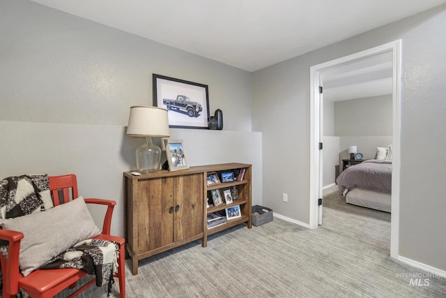 sitting room featuring carpet flooring and baseboards