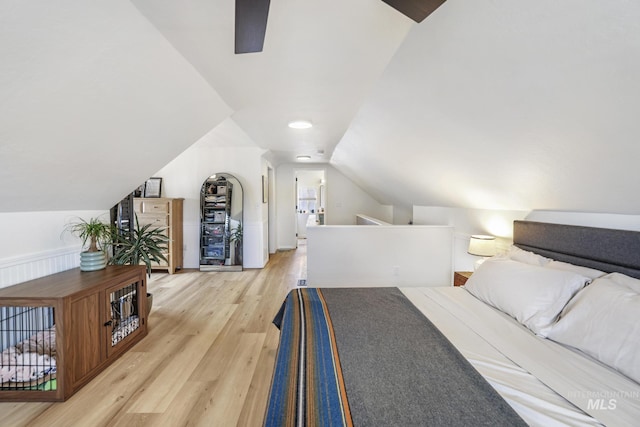 bedroom with lofted ceiling and light wood-style floors