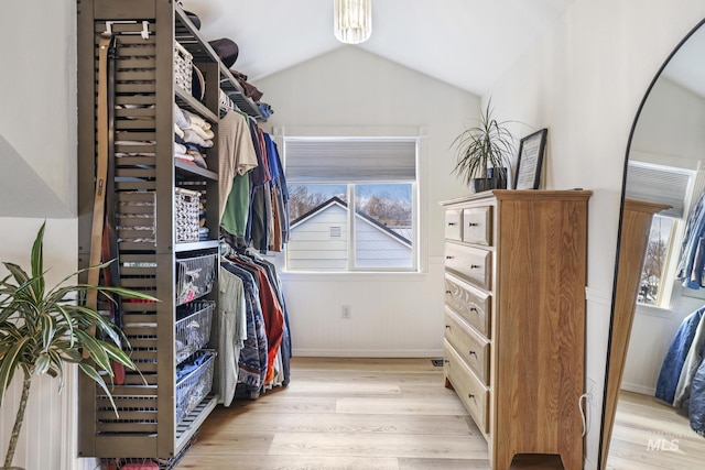 walk in closet featuring lofted ceiling and light wood-type flooring