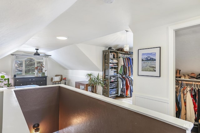 interior space featuring lofted ceiling and wainscoting