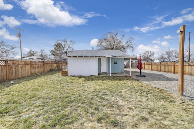 view of outbuilding with a fenced backyard and an outbuilding