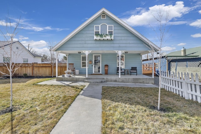 exterior space with a porch, a yard, and fence