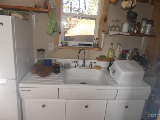 309 Wildrose Ln, Anatone, WA 99401 - kitchen featuring white fridge, white cabinetry, and sink