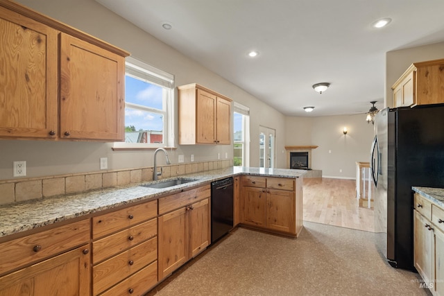 1141 Liberty Dr, Clarkston, WA 99403 - kitchen with dishwasher, a sink, freestanding refrigerator, ceiling fan, and a peninsula