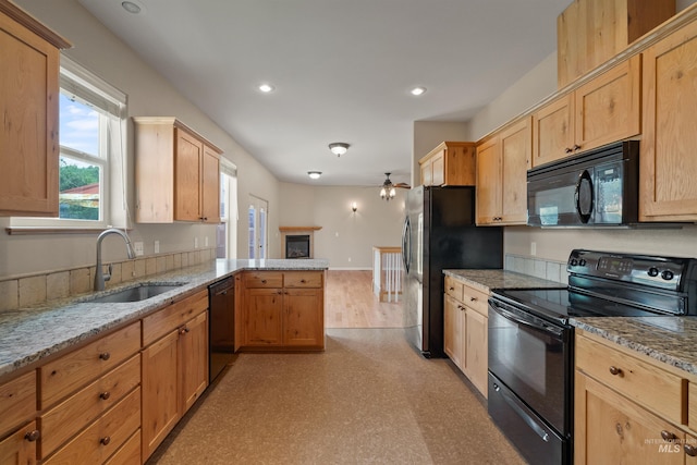 1141 Liberty Dr, Clarkston, WA 99403 - kitchen with black appliances, a sink, a peninsula, ceiling fan, and light stone countertops