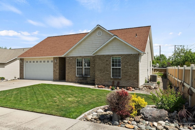1141 Liberty Dr, Clarkston, WA 99403 - view of front of home with a garage, concrete driveway, brick siding, cooling unit, and roof with shingles