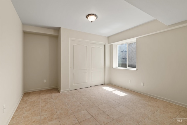 1141 Liberty Dr, Clarkston, WA 99403 - unfurnished bedroom featuring a closet, light tile patterned floors, and baseboards