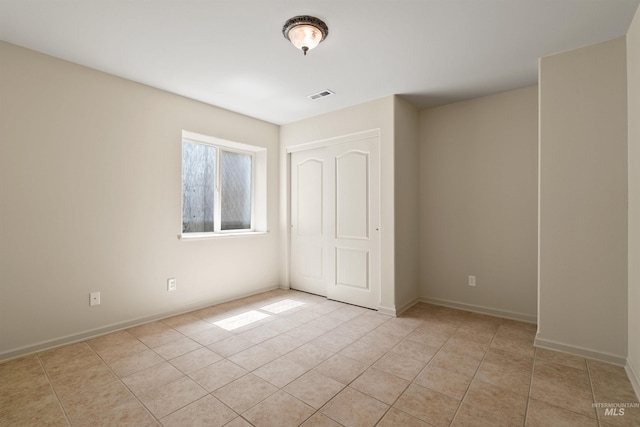 1141 Liberty Dr, Clarkston, WA 99403 - unfurnished bedroom with light tile patterned flooring, a closet, and baseboards
