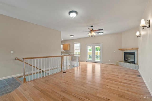 1141 Liberty Dr, Clarkston, WA 99403 - unfurnished living room featuring wood finished floors, baseboards, a ceiling fan, and a tile fireplace