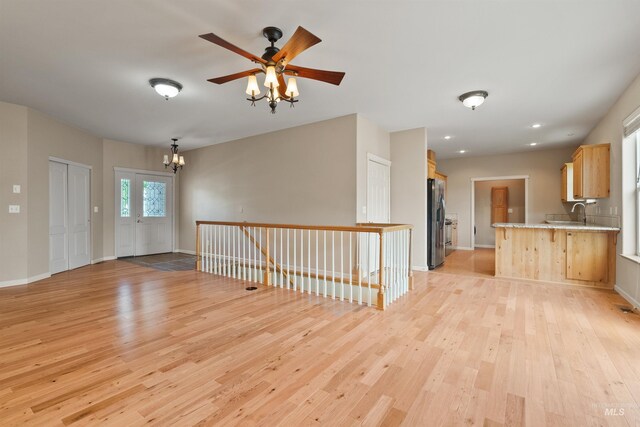 1141 Liberty Dr, Clarkston, WA 99403 - entryway featuring light wood finished floors, a chandelier, ceiling fan, and baseboards