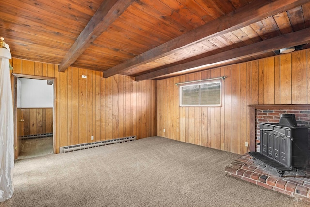 unfurnished living room featuring wooden walls, wood ceiling, a wood stove, a baseboard heating unit, and beam ceiling