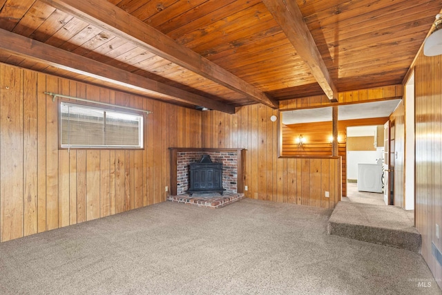 unfurnished living room with washer / clothes dryer, wooden ceiling, wood walls, and beam ceiling