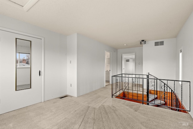 empty room featuring carpet and visible vents